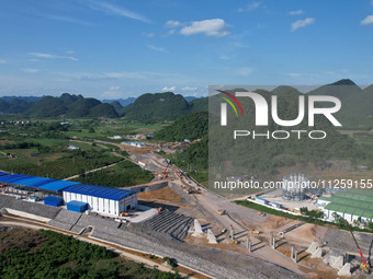 Workers are working at the construction site of a highway in Jiangbian village, Liuzhou city, South China's Guangxi Zhuang Autonomous region...