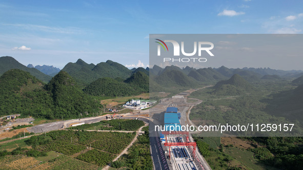 Workers are working at the construction site of a highway in Jiangbian village, Liuzhou city, South China's Guangxi Zhuang Autonomous region...