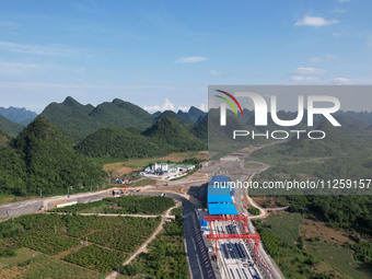 Workers are working at the construction site of a highway in Jiangbian village, Liuzhou city, South China's Guangxi Zhuang Autonomous region...