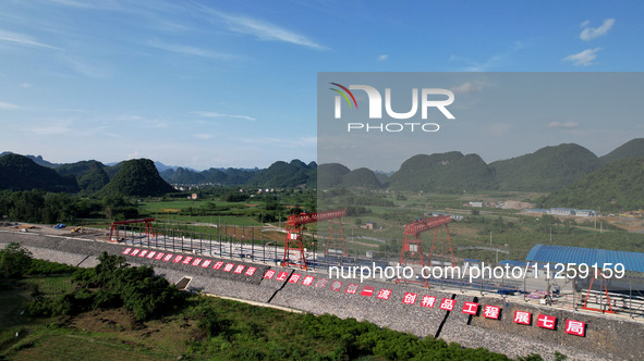 Workers are working at the construction site of a highway in Jiangbian village, Liuzhou city, South China's Guangxi Zhuang Autonomous region...