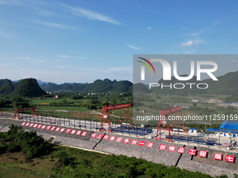 Workers are working at the construction site of a highway in Jiangbian village, Liuzhou city, South China's Guangxi Zhuang Autonomous region...