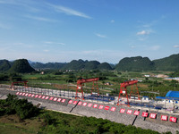 Workers are working at the construction site of a highway in Jiangbian village, Liuzhou city, South China's Guangxi Zhuang Autonomous region...