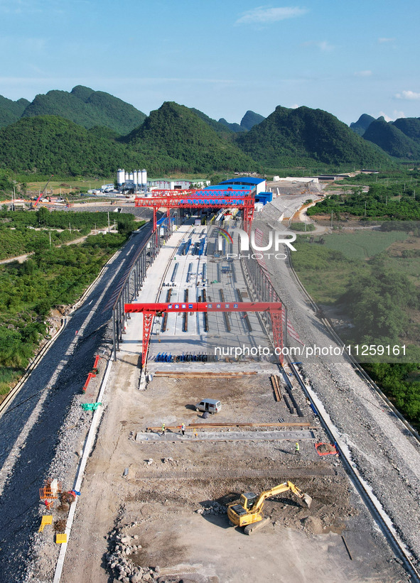 Workers are working at the construction site of a highway in Jiangbian village, Liuzhou city, South China's Guangxi Zhuang Autonomous region...