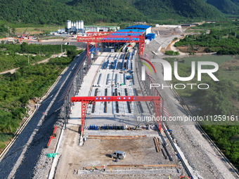 Workers are working at the construction site of a highway in Jiangbian village, Liuzhou city, South China's Guangxi Zhuang Autonomous region...