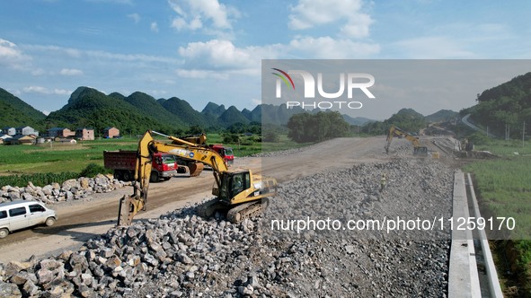 Workers are working at the construction site of a highway in Jiangbian village, Liuzhou city, South China's Guangxi Zhuang Autonomous region...