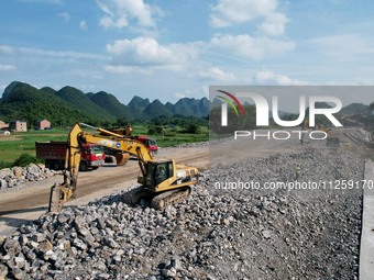 Workers are working at the construction site of a highway in Jiangbian village, Liuzhou city, South China's Guangxi Zhuang Autonomous region...