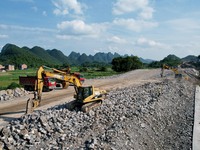 Workers are working at the construction site of a highway in Jiangbian village, Liuzhou city, South China's Guangxi Zhuang Autonomous region...