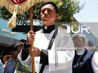 A priest is taking part in the traditional downing of the Virgen de Ocotlan. In this procession, the virgin is visiting different emblematic...