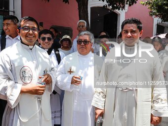 Priests are taking part in the traditional downing of the Virgen de Ocotlan. In this procession, the virgin is visiting different emblematic...