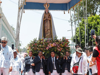 People are carrying the Virgen de Ocotlan while walking on a sawdust carpet during the traditional downing of the Virgen de Ocotlan. In this...