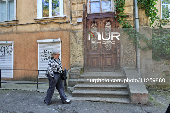 A woman is being seen in a courtyard in the historic city center in Odesa, Ukraine, on May 20, 2024. NO USE RUSSIA. NO USE BELARUS. 