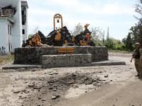 A soldier is standing by the monument to the warriors of the Soviet-Afghan War outside the Palace of Culture destroyed by Russian shelling o...