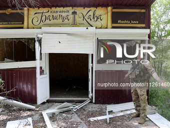 A serviceman is standing by a coffee shop destroyed by Russian shelling in Chasiv Yar, Ukraine, on May 18, 2024. NO USE RUSSIA. NO USE BELAR...