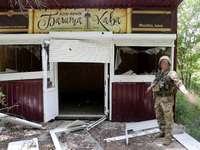 A serviceman is standing by a coffee shop destroyed by Russian shelling in Chasiv Yar, Ukraine, on May 18, 2024. NO USE RUSSIA. NO USE BELAR...