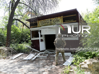 A serviceman is standing by a coffee shop destroyed by Russian shelling in Chasiv Yar, Ukraine, on May 18, 2024. NO USE RUSSIA. NO USE BELAR...