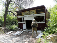 A serviceman is standing by a coffee shop destroyed by Russian shelling in Chasiv Yar, Ukraine, on May 18, 2024. NO USE RUSSIA. NO USE BELAR...