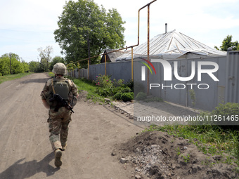 A serviceman is patrolling the streets in Chasiv Yar, Donetsk region, eastern Ukraine, on May 18, 2024. NO USE RUSSIA. NO USE BELARUS. (