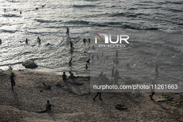 Palestinians are gathering on the beach in Deir el-Balah in the central Gaza Strip, on May 21, 2024, amid the ongoing conflict between Israe...