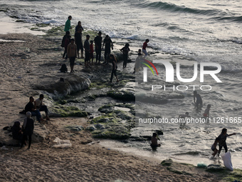 Palestinians are gathering on the beach in Deir el-Balah in the central Gaza Strip, on May 21, 2024, amid the ongoing conflict between Israe...