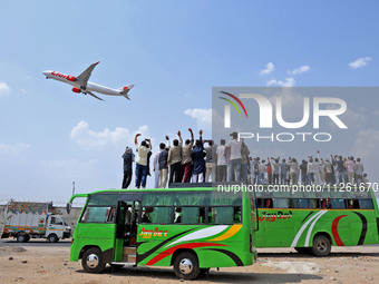 Relatives are standing atop buses as they see off Haj pilgrims, leaving on a flight, in Jaipur, Rajasthan, India, on May 21, 2024. (