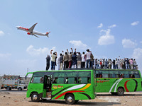 Relatives are standing atop buses as they see off Haj pilgrims, leaving on a flight, in Jaipur, Rajasthan, India, on May 21, 2024. (