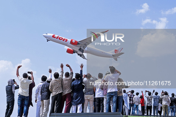 Relatives are standing atop buses as they see off Haj pilgrims, leaving on a flight, in Jaipur, Rajasthan, India, on May 21, 2024. 