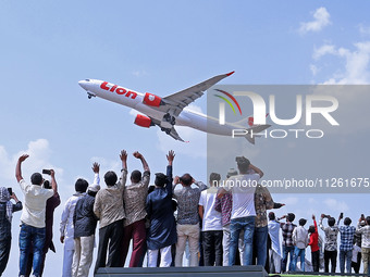 Relatives are standing atop buses as they see off Haj pilgrims, leaving on a flight, in Jaipur, Rajasthan, India, on May 21, 2024. (