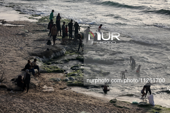 Palestinians are gathering on the beach in Deir el-Balah in the central Gaza Strip, on May 21, 2024, amid the ongoing conflict between Israe...