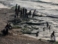 Palestinians are gathering on the beach in Deir el-Balah in the central Gaza Strip, on May 21, 2024, amid the ongoing conflict between Israe...