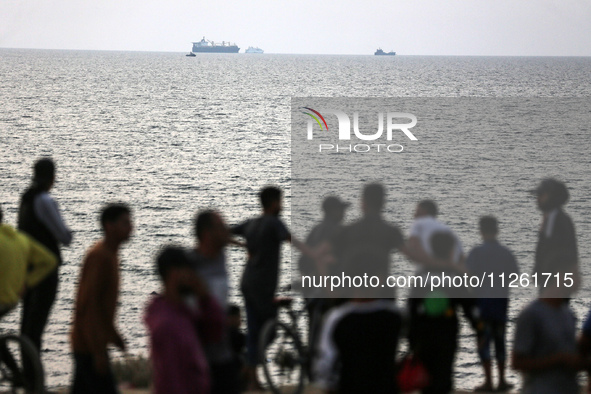 Palestinians are gathering in the hope of obtaining aid delivered into Gaza through a U.S.-built pier, amid the ongoing conflict between Isr...