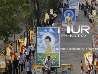 Buddhist people are taking part in a rally on the occasion of the Buddha Purnima festival, which marks the birth of Gautam Buddha, in Dhaka,...