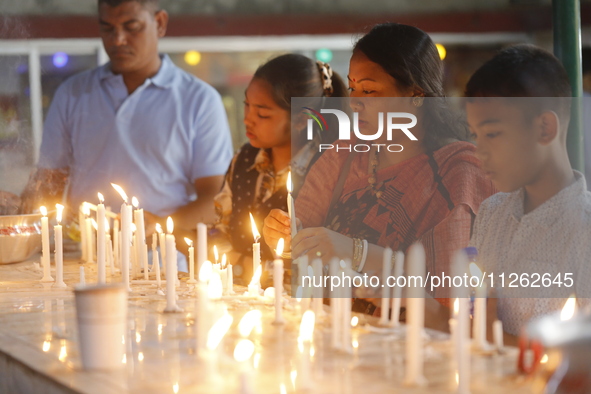 Buddhist devotees are lighting candles at a temple on the occasion of the Buddha Purnima festival, which marks the birth of Gautam Buddha, i...