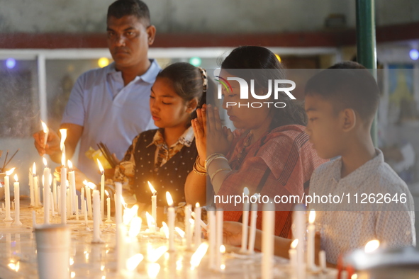 Buddhist devotees are lighting candles at a temple on the occasion of the Buddha Purnima festival, which marks the birth of Gautam Buddha, i...