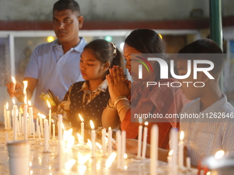 Buddhist devotees are lighting candles at a temple on the occasion of the Buddha Purnima festival, which marks the birth of Gautam Buddha, i...