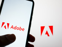 The Adobe logo is being displayed on a smartphone screen and on a computer screen in Athens, Greece, on May 22, 2024. (
