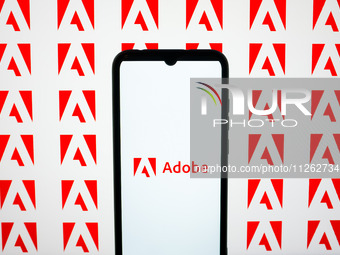The Adobe logos are being displayed on a smartphone screen and on a computer screen in Athens, Greece, on May 22, 2024. (