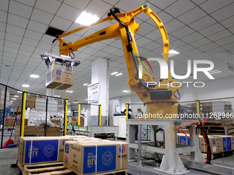 A robot is making an order for textile chemical fiber on a production line in Fuzhou, Fujian province, China, on May 22, 2024. (