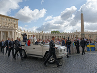 Pope Francis is waving to the crowd during his weekly general audience in Vatican City, on May 22, 2024. (