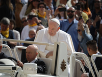 Pope Francis is waving to the crowd during his weekly general audience in Vatican City, on May 22, 2024. (