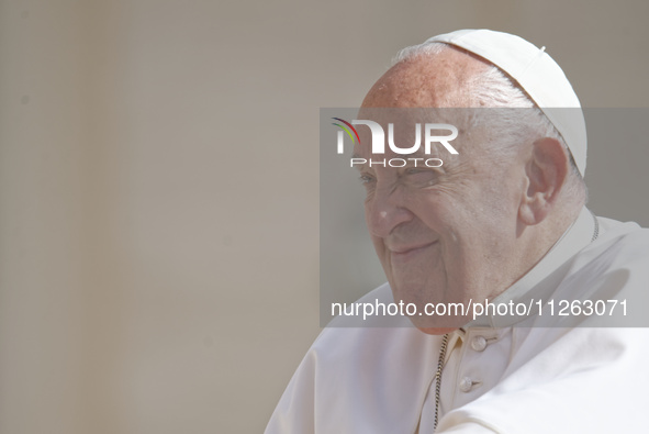 Pope Francis is smiling during his weekly general audience in Vatican City, on May 22, 2024. 