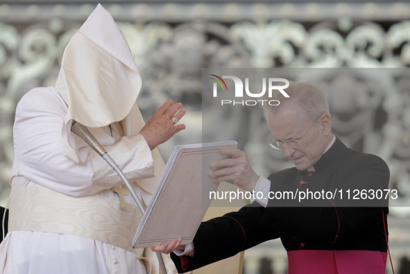 Winds are moving Pope Francis' pellegrina as he is leading his weekly General Audience in Saint Peter's Square, Vatican City, on May 22, 202...