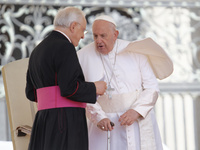 Pope Francis is talking with Monsignor Leonardo Sappienza at the end of his weekly general audience in Vatican City, on May 22, 2024 (