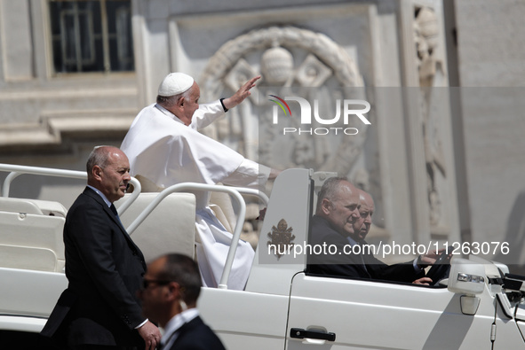 Pope Francis is leaving St. Peter's Square at the end of his weekly general audience in Vatican City, on May 22, 2024. 