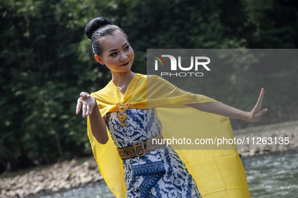 Dancers are performing a traditional dance during the Fang Sen ritual, or releasing animals into nature, as part of a series of worship ahea...