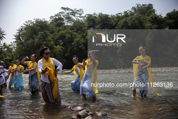 Dancers are performing a traditional dance during the Fang Sen ritual, or releasing animals into nature, as part of a series of worship ahea...