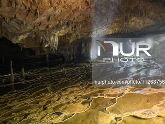 Outdoor lovers are exploring an underground karst cave in Qiannan Buyi and Miao autonomous Prefecture, in Qiannan, China, on May 22, 2024. (