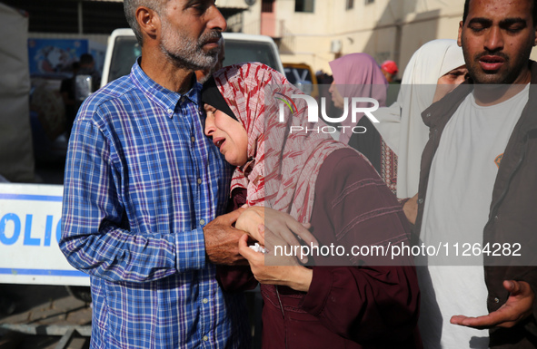 A displaced Palestinian mother is showering her child amid a heat wave inside a tent at a temporary camp in Deir el-Balah in the central Gaz...