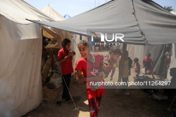 Displaced Palestinian children are playing outside their tents amid a heat wave at a temporary camp in Deir el-Balah in the central Gaza Str...