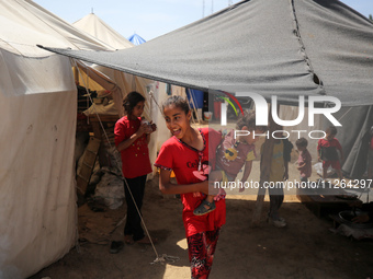 Displaced Palestinian children are playing outside their tents amid a heat wave at a temporary camp in Deir el-Balah in the central Gaza Str...