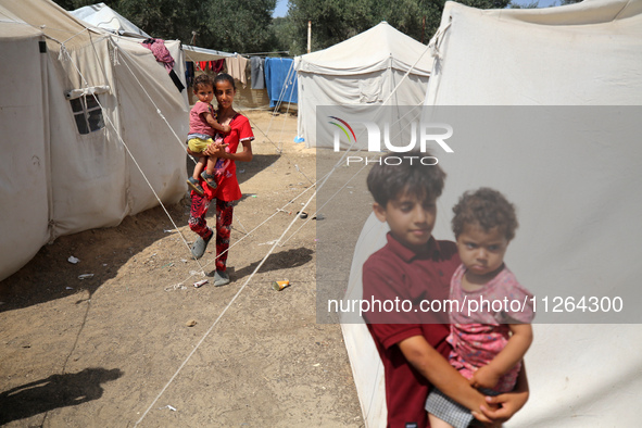 Displaced Palestinian children are playing outside their tents amid a heat wave at a temporary camp in Deir el-Balah in the central Gaza Str...